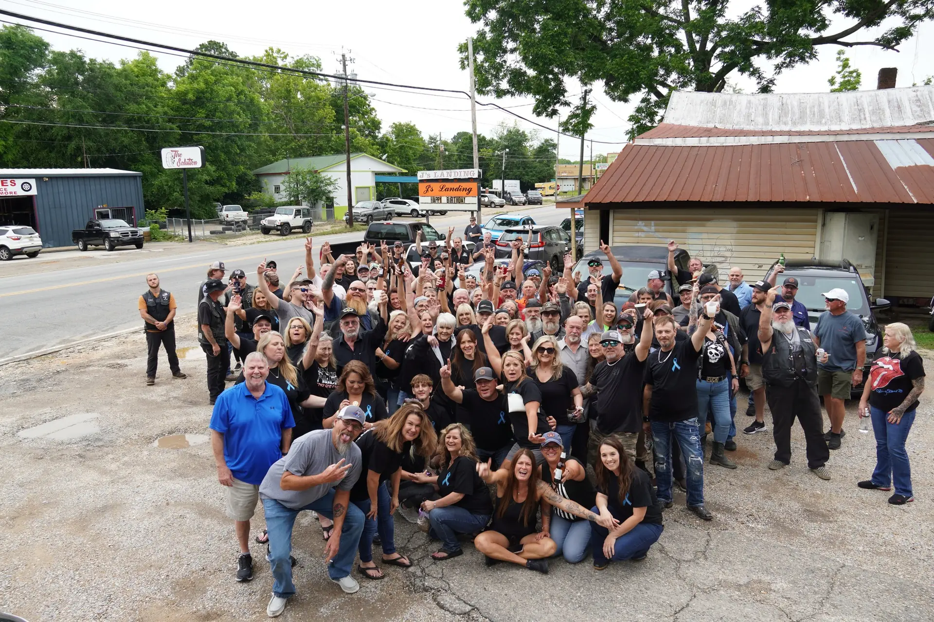 A crowd gathered in the parking lot at J's Landing